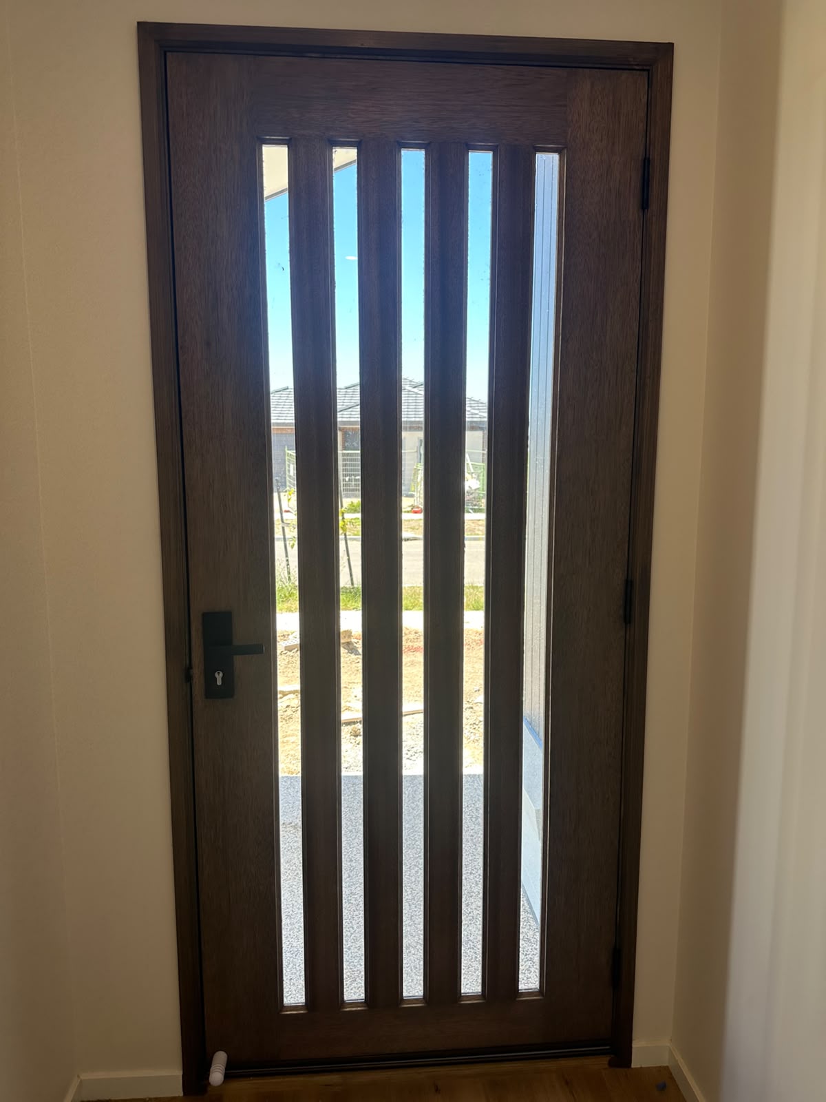Interior view of stained solid timber entrance door and jamb