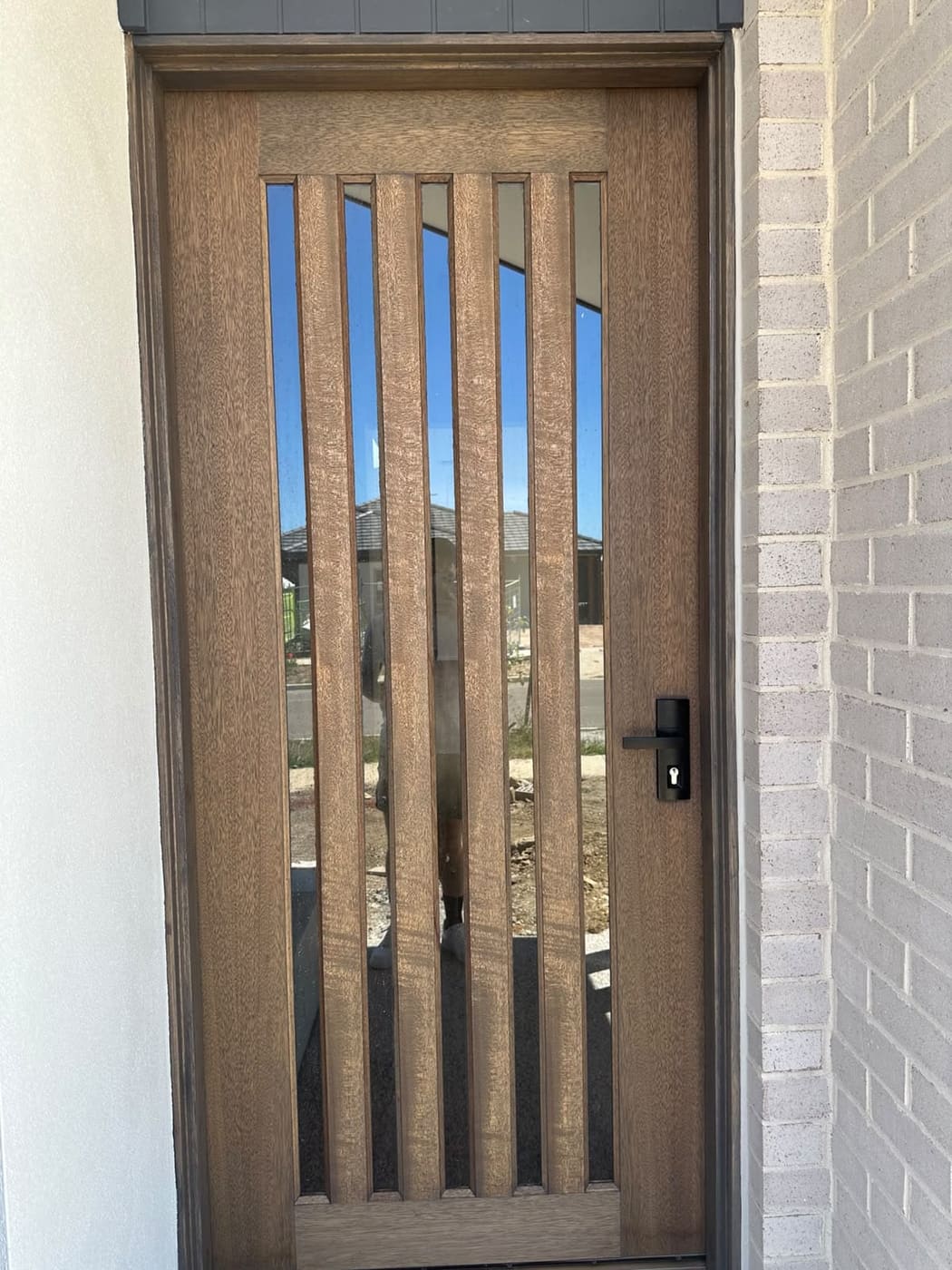 Stained solid walnut timber front door finished by ZN Painting Services