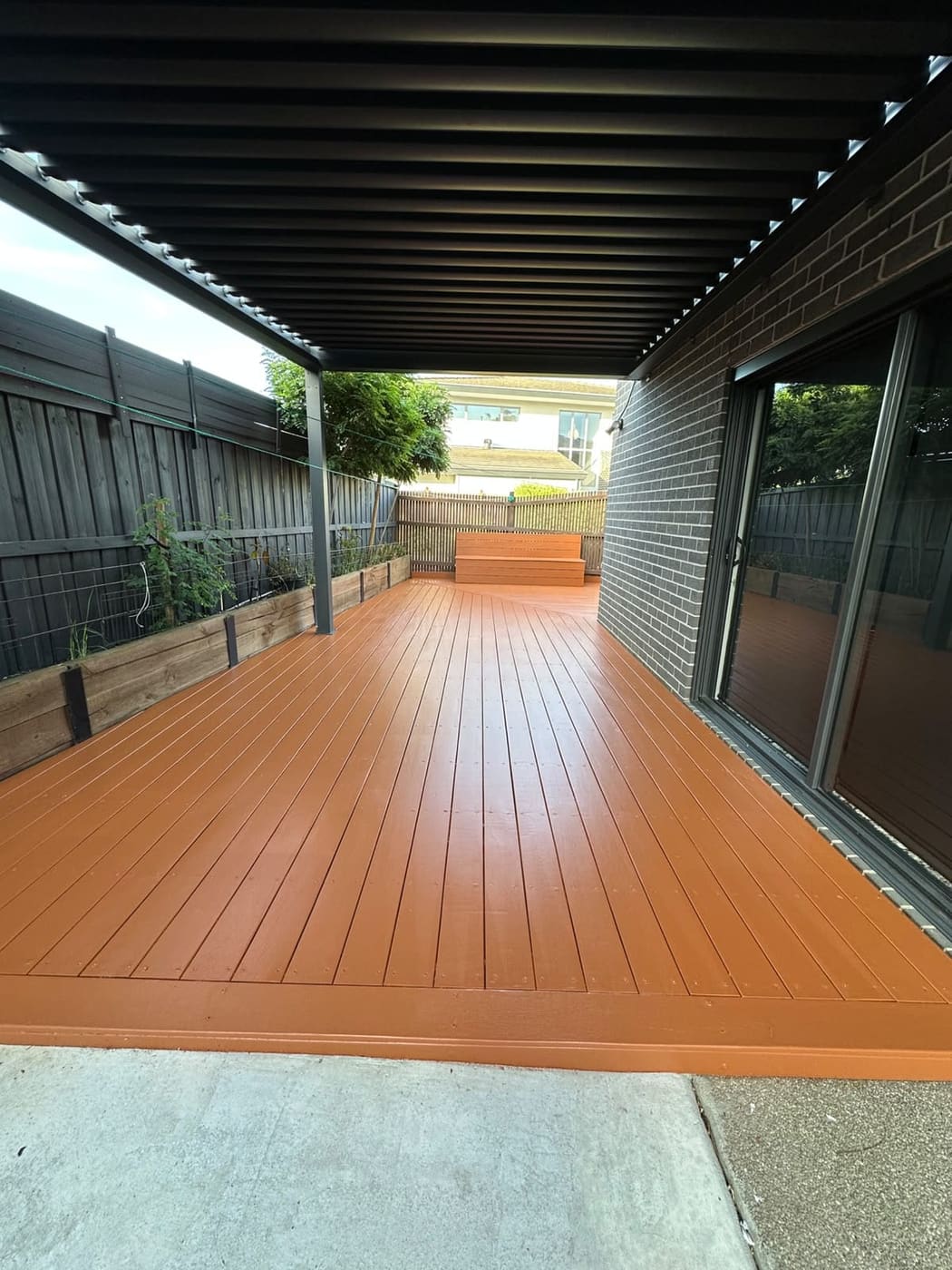 Freshly oiled pergola timber deck showing rich natural grain