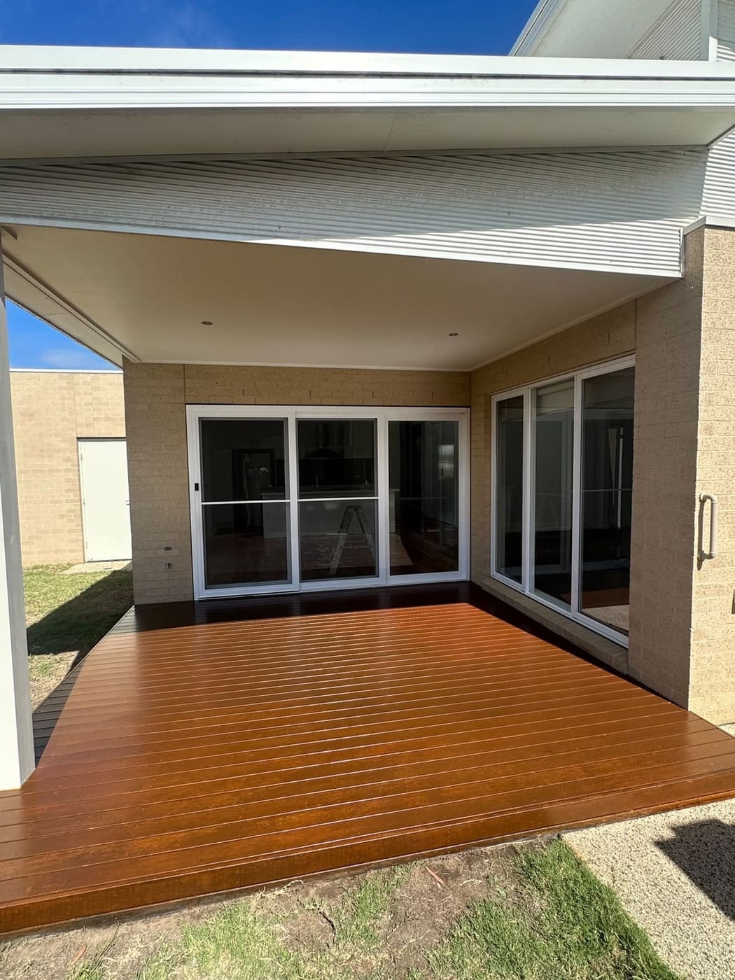 Backyard entertaining deck finished in rich dark walnut decking stain
