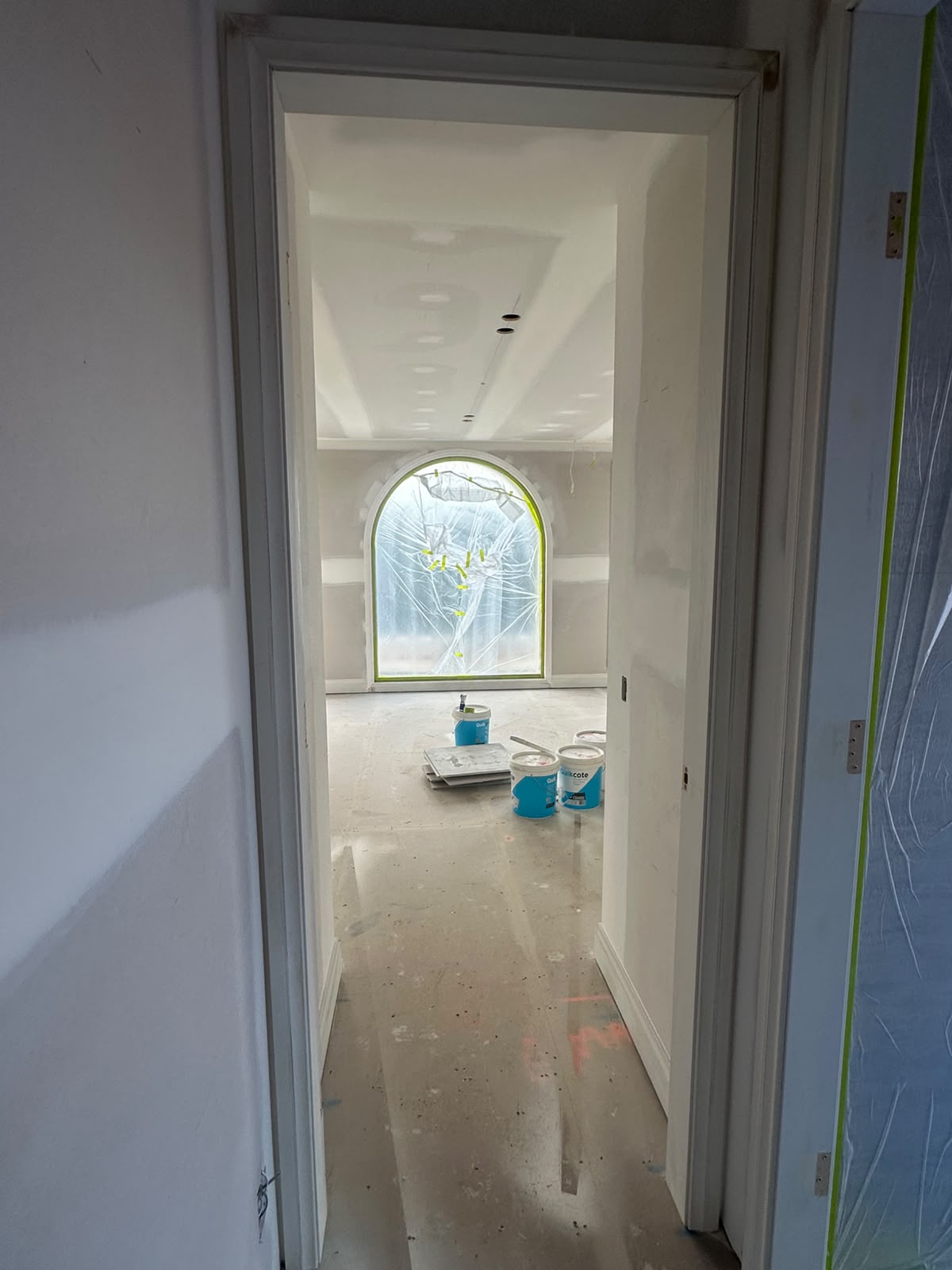 Complete protective drop-sheets and masking covering new build flooring