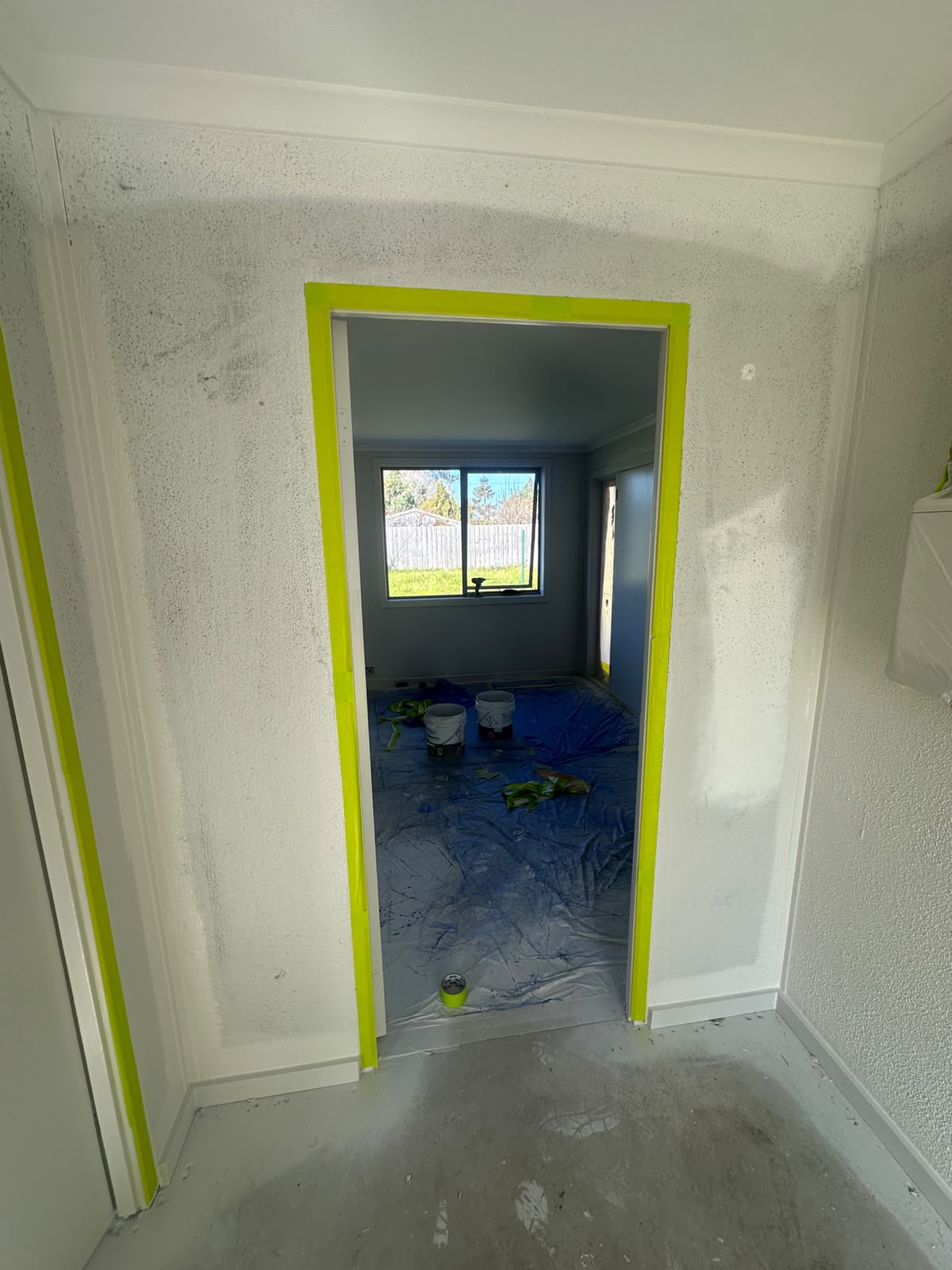 Textured acrylic render finish on internal hallway walls