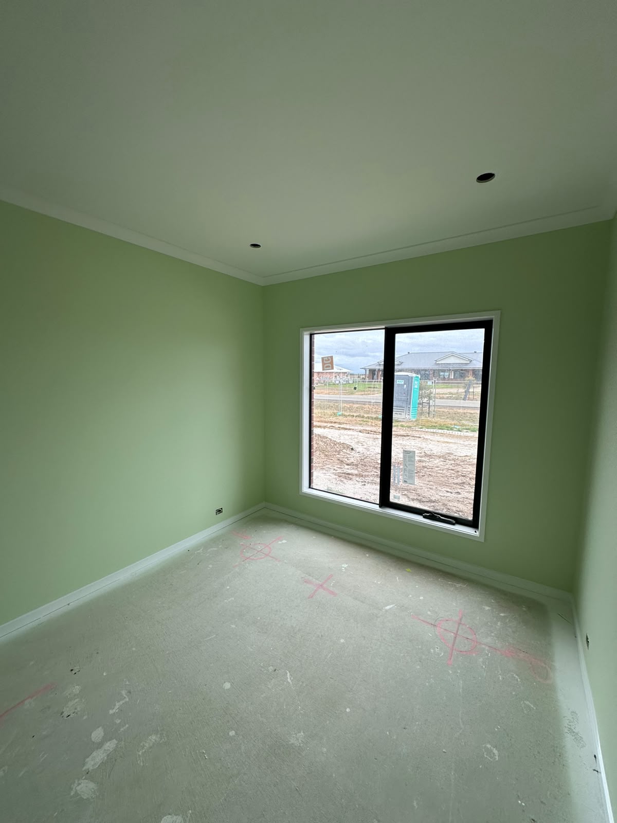 New home hallway interior repainted in soft sage green with bright white cornices
